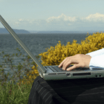 woman laptop beach